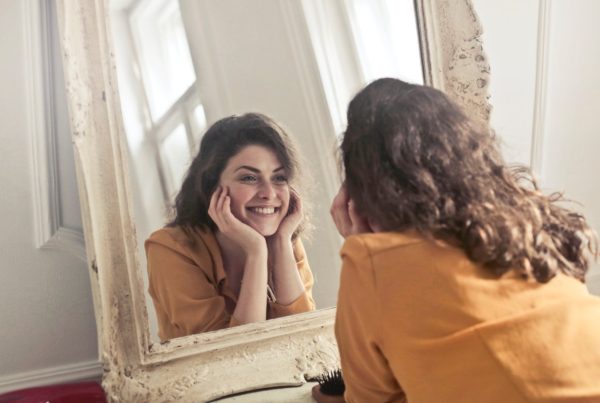 Woman staring into mirror, illustrating vanity in accountant marketing