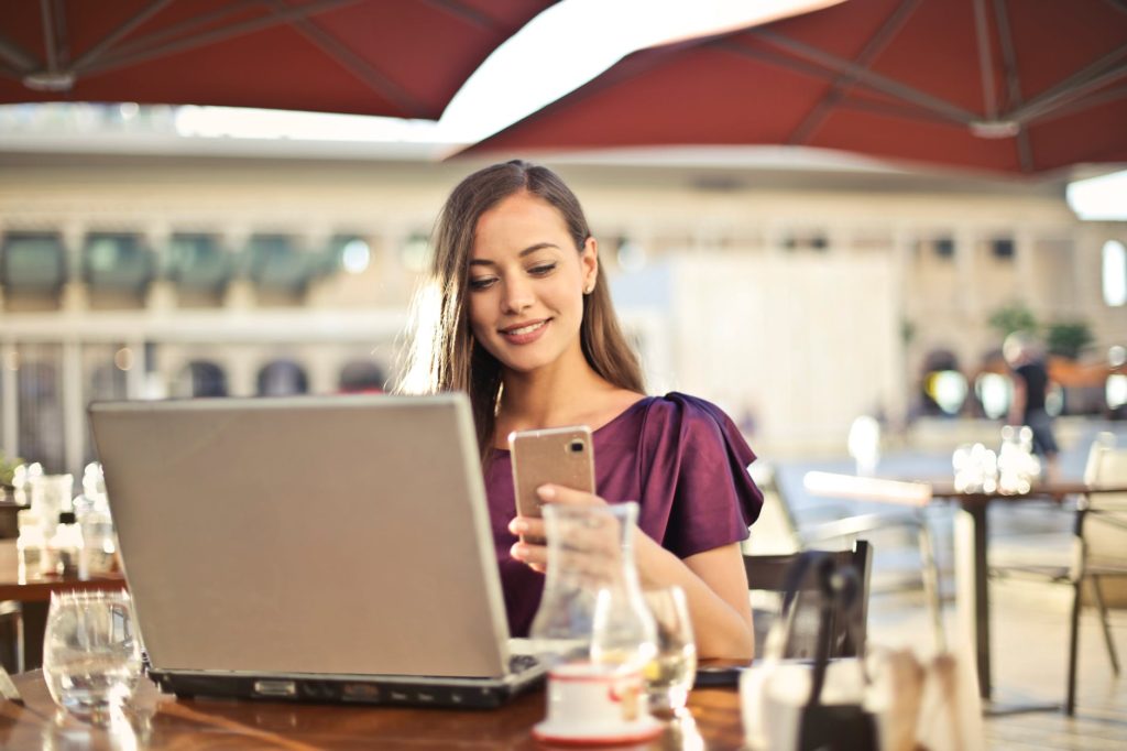 Woman on accounting website looking at her mobile phone